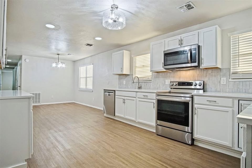 Tessa Hood Realtor – Kitchen with stainless range, dishwasher, and tile backsplash at 1112 County Street 2910, Tuttle Oklahoma