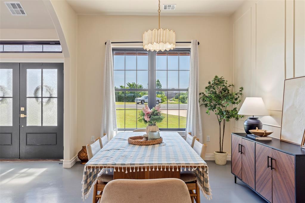 Tessa Hood Realtor – Formal dining room with crystal chandelier and large picture window at 1074 Fawn Meadow Dr, Blanchard Oklahoma