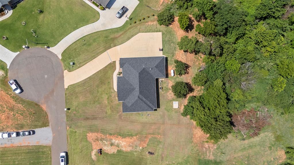 Tessa Hood Realtor – Aerial overhead view showing 1.23 acre wooded lot and pond access at 1074 Fawn Meadow Dr, Blanchard Oklahoma