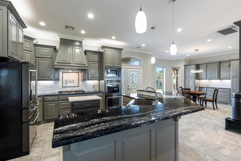 Tessa Hood Realtor – Custom kitchen with hood, granite island, and dining area at 516 Kings Ct, Tuttle Oklahoma