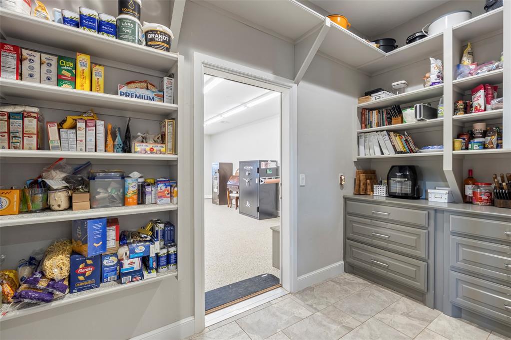 Tessa Hood Realtor – Walk-in pantry with built-in shelving and safe room access at 516 Kings Ct, Tuttle Oklahoma