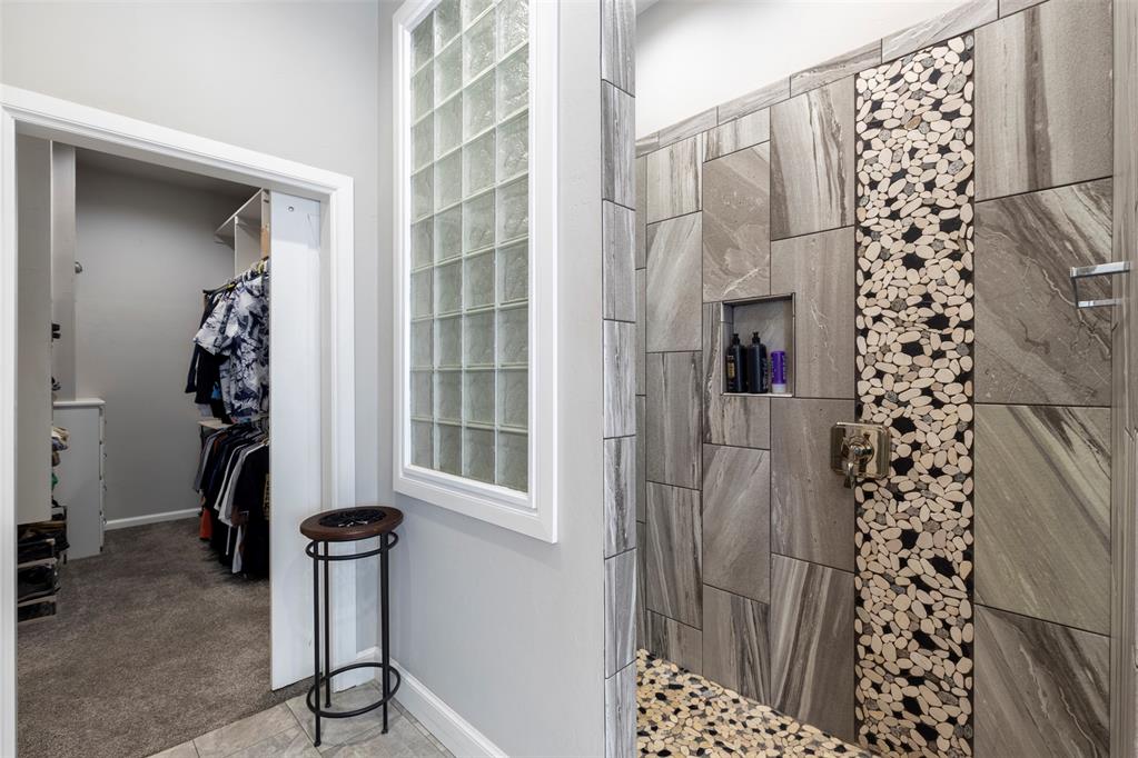 Tessa Hood Realtor – Walk-in shower with pebble tile accent and closet entry at 516 Kings Ct, Tuttle Oklahoma