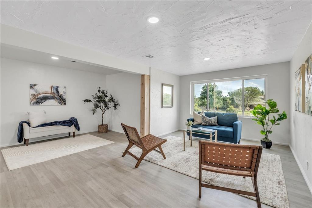 Tessa Hood Realtor – Remodeled living room with new LVP flooring and natural light at 7400 Lakewood Dr, Mustang Oklahoma