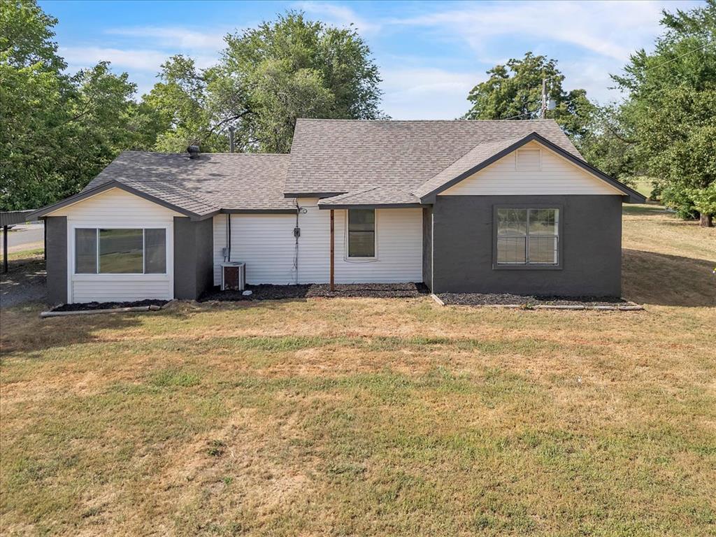 Tessa Hood Realtor – Exterior side view with fresh paint, new windows, and updated landscaping at 7400 Lakewood Dr, Mustang Oklahoma