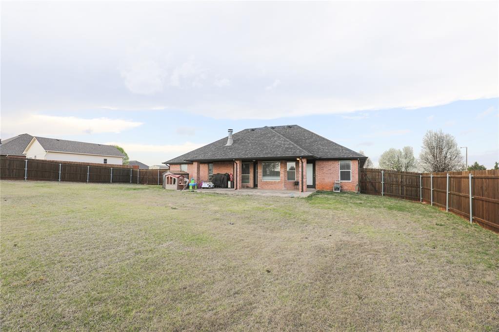 Tessa Hood Realtor – Rear exterior with covered patio and fenced yard at 6910 Rolling Meadows Dr, Tuttle Oklahoma