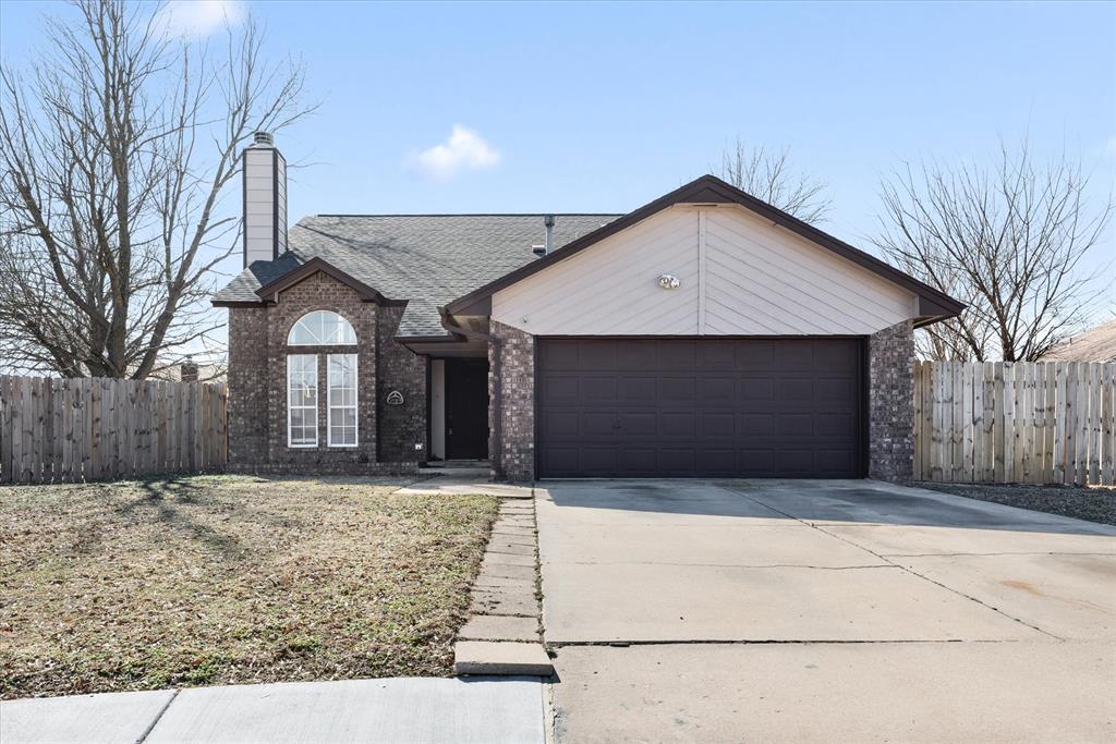 Tessa Hood Realtor – Brick exterior front view with two-car garage at 2028 Rose Court, Norman Oklahoma