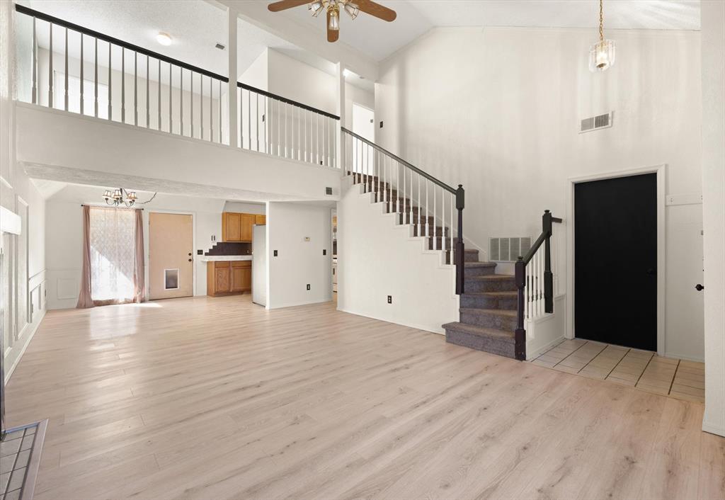 Tessa Hood Realtor – Open-concept living room with new LVP flooring at 2028 Rose Court, Norman Oklahoma