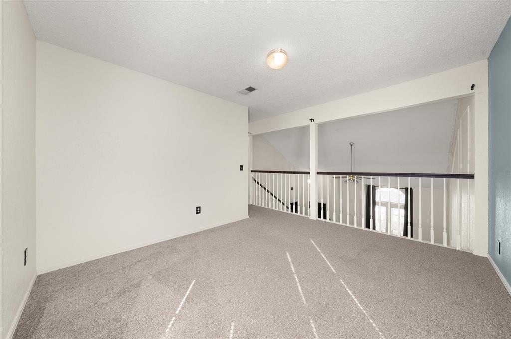 Tessa Hood Realtor – Loft bonus room overlooking the vaulted living room at 2028 Rose Court, Norman Oklahoma