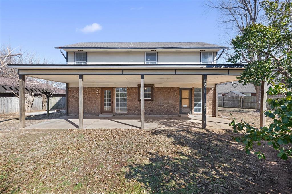 Tessa Hood Realtor – Large covered back patio and brick rear exterior at 2028 Rose Court, Norman Oklahoma