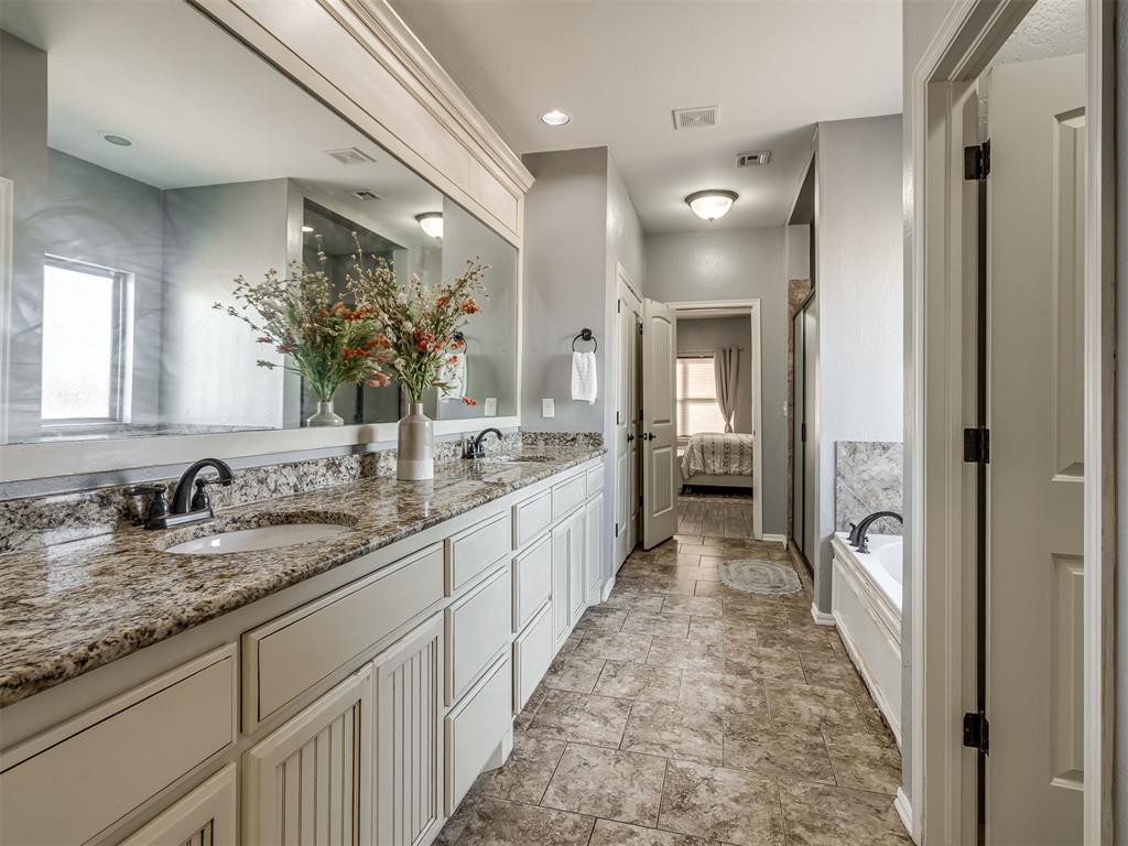 Tessa Hood Realtor – Primary bath double vanity with granite counters at 5708 SE 148th St, Oklahoma City OK