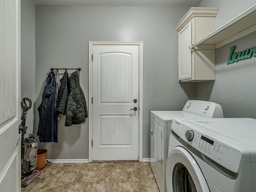 Tessa Hood Realtor – Laundry room with washer, dryer, and cabinet storage at 5708 SE 148th St, Oklahoma City OK