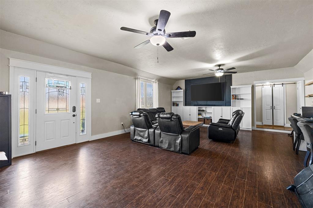 Tessa Hood Realtor – Spacious living room with wood floors and built-in entertainment center at 21063 State Hwy 76, Blanchard Oklahoma