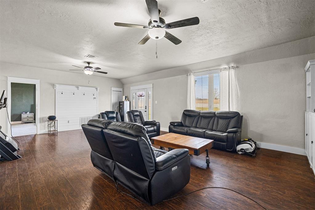 Tessa Hood Realtor – Open living room with wood floors and natural light at 21063 State Hwy 76, Blanchard Oklahoma