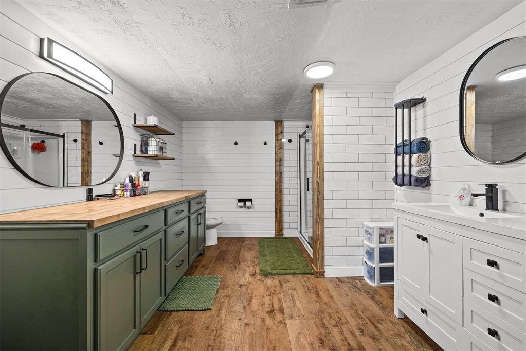 Tessa Hood Realtor – Primary bathroom with dual vanities, subway tile, and walk-in shower at 21063 State Hwy 76, Blanchard Oklahoma