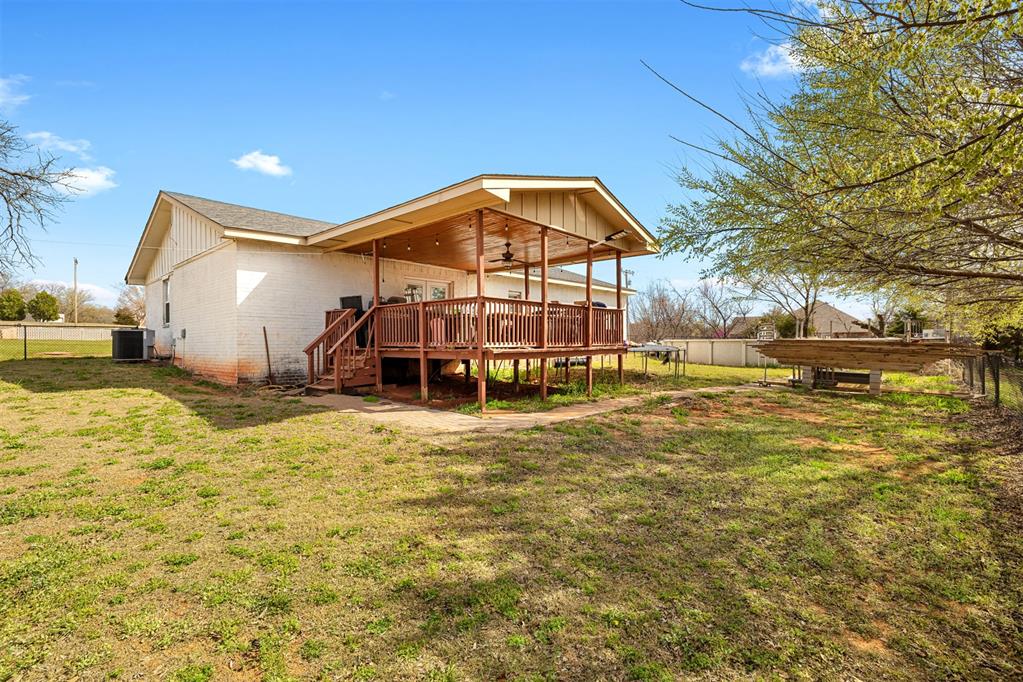 Tessa Hood Realtor – Covered back deck with ceiling fan and large yard at 21063 State Hwy 76, Blanchard Oklahoma
