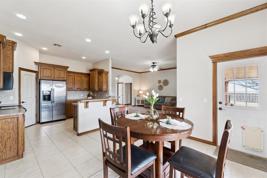 Tessa Hood Realtor – Dining area with chandelier and open kitchen at 1928 SW 9th St, Newcastle Oklahoma