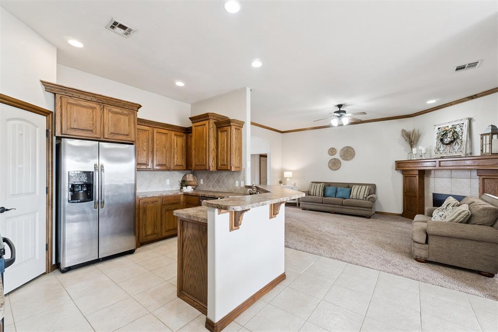 Tessa Hood Realtor – Kitchen with custom cabinetry, island, and stainless refrigerator at 1928 SW 9th St, Newcastle Oklahoma