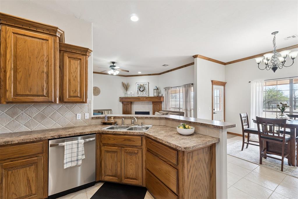 Tessa Hood Realtor – Kitchen with granite counters, tile backsplash, and stainless dishwasher at 1928 SW 9th St, Newcastle Oklahoma