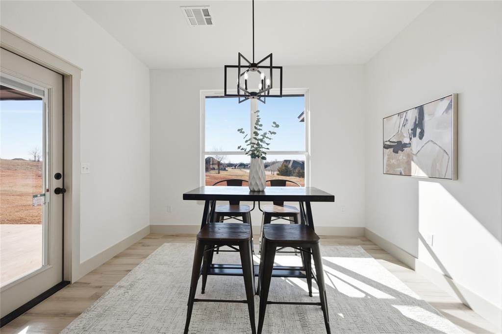 Tessa Hood Realtor – Bright dining room with modern chandelier at 2439 Wind River Cir, Blanchard Oklahoma