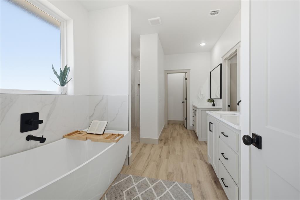 Tessa Hood Realtor – Primary bathroom with freestanding soaking tub and double vanity at 2439 Wind River Cir, Blanchard Oklahoma